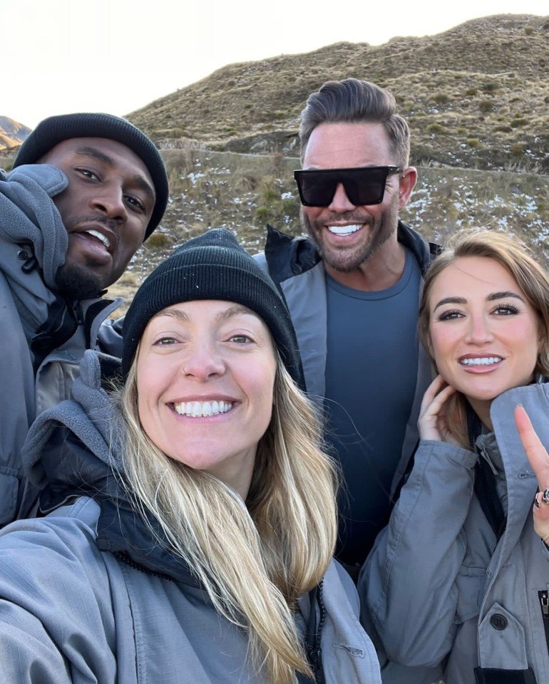 a group of people posing for a picture with one wearing sunglasses