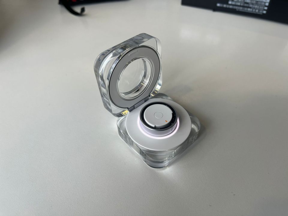 a clear container with a button on the top of it