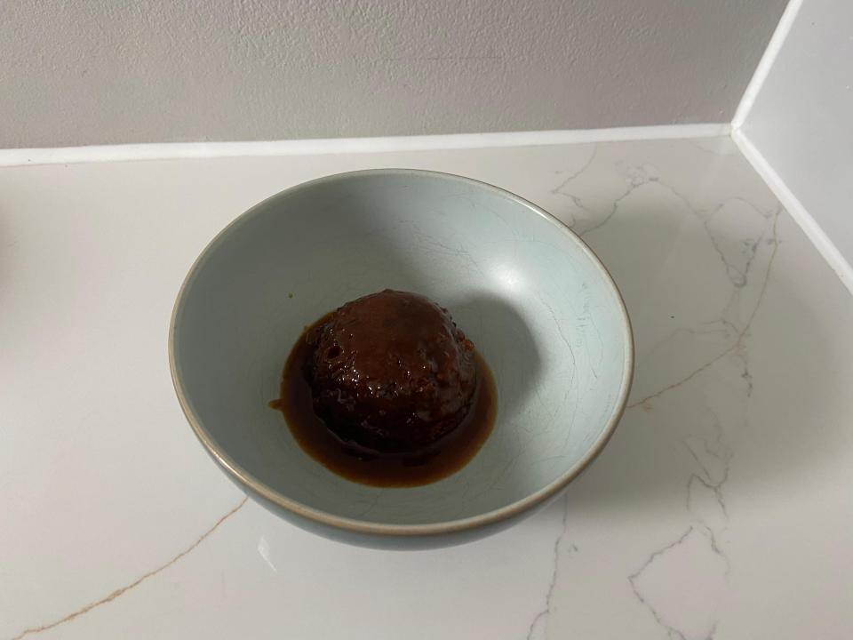 a blue bowl filled with a brown liquid on a counter