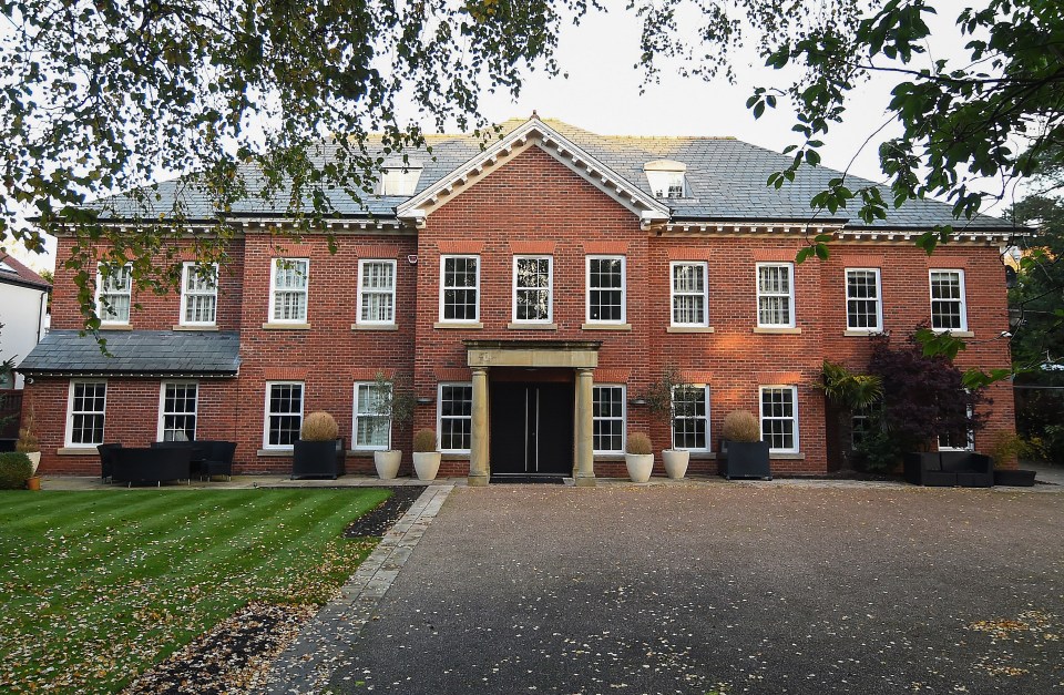 a large brick house with a driveway in front of it