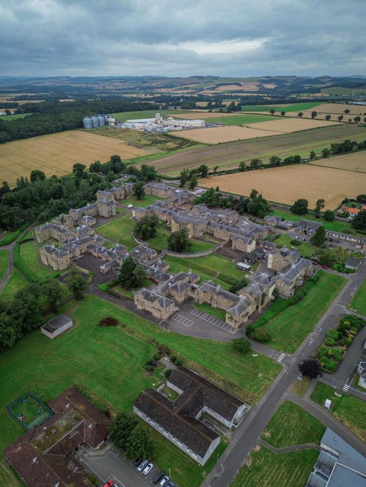 an aerial view of a residential area surrounded by fields