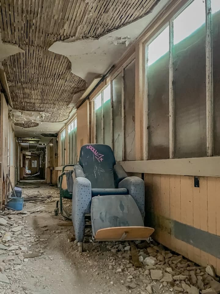 a chair in a hallway has the word hawks painted on it