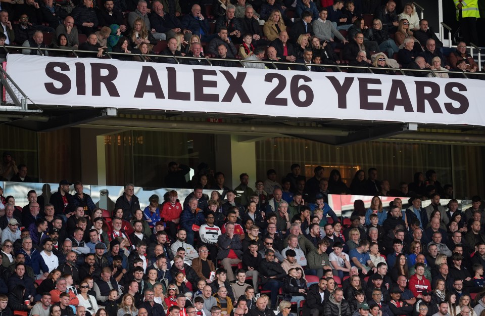 a stadium full of people with a banner that says sir alex 26 years