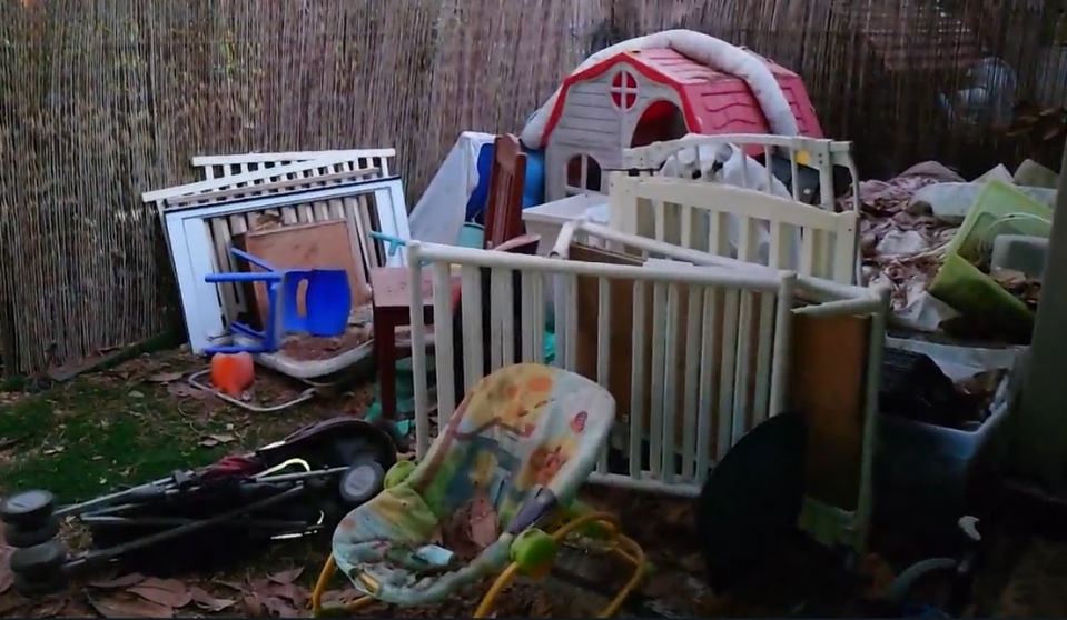 a baby bouncer sits in the middle of a pile of junk