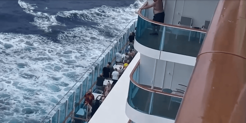 a man stands on a balcony on a cruise ship