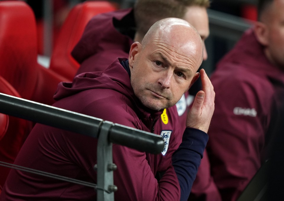a bald man wearing a maroon sweatshirt with the word goal on it