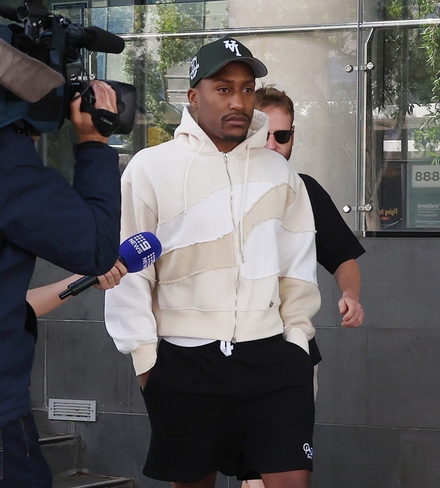 a man wearing a hat with the letter t on it