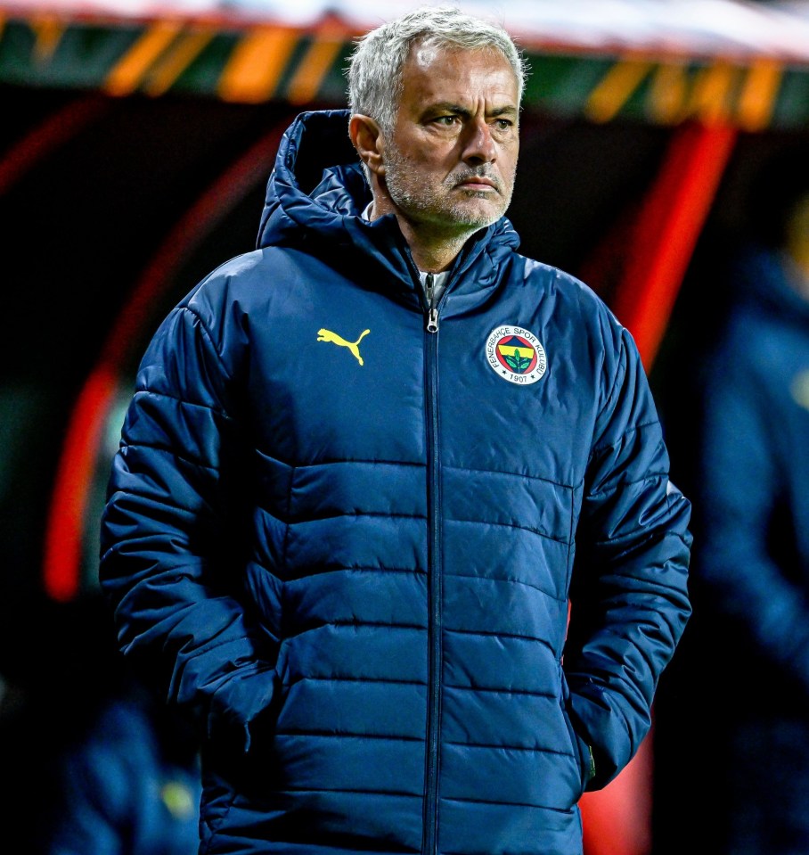 a man wearing a blue jacket with a puma logo on it