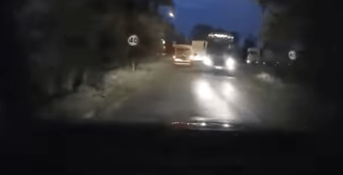 a car is driving down a road with a speed limit of 40