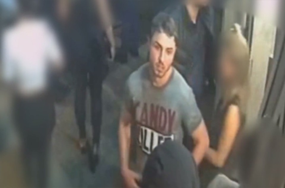 a man wearing a candy shirt is surrounded by people