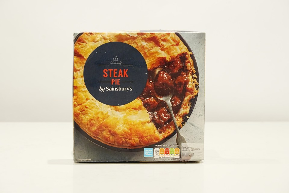 a box of sainsbury 's steak pie with a spoon in it