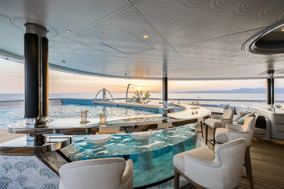 a large swimming pool with a bar in the middle of it