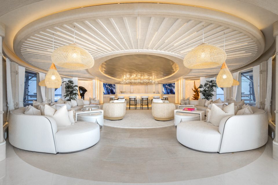 a living room with white furniture and a circular ceiling