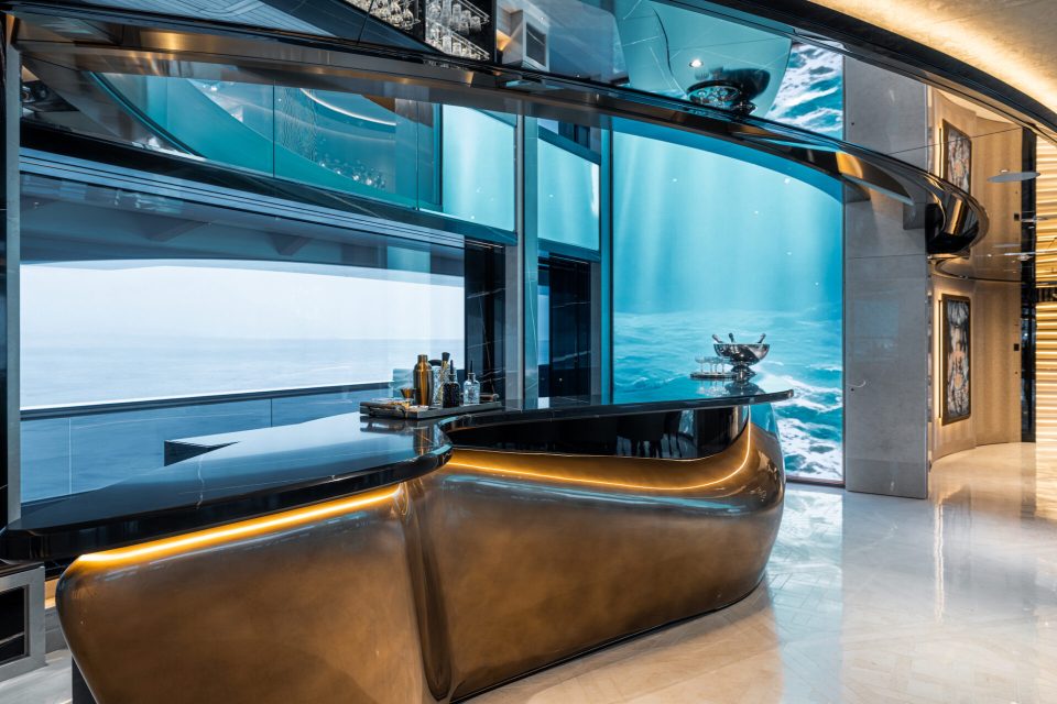 a bar with a large aquarium in the background