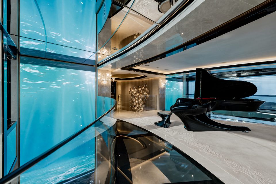 a piano in a room with a glass wall
