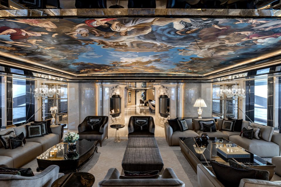 a living room with a large painting on the ceiling
