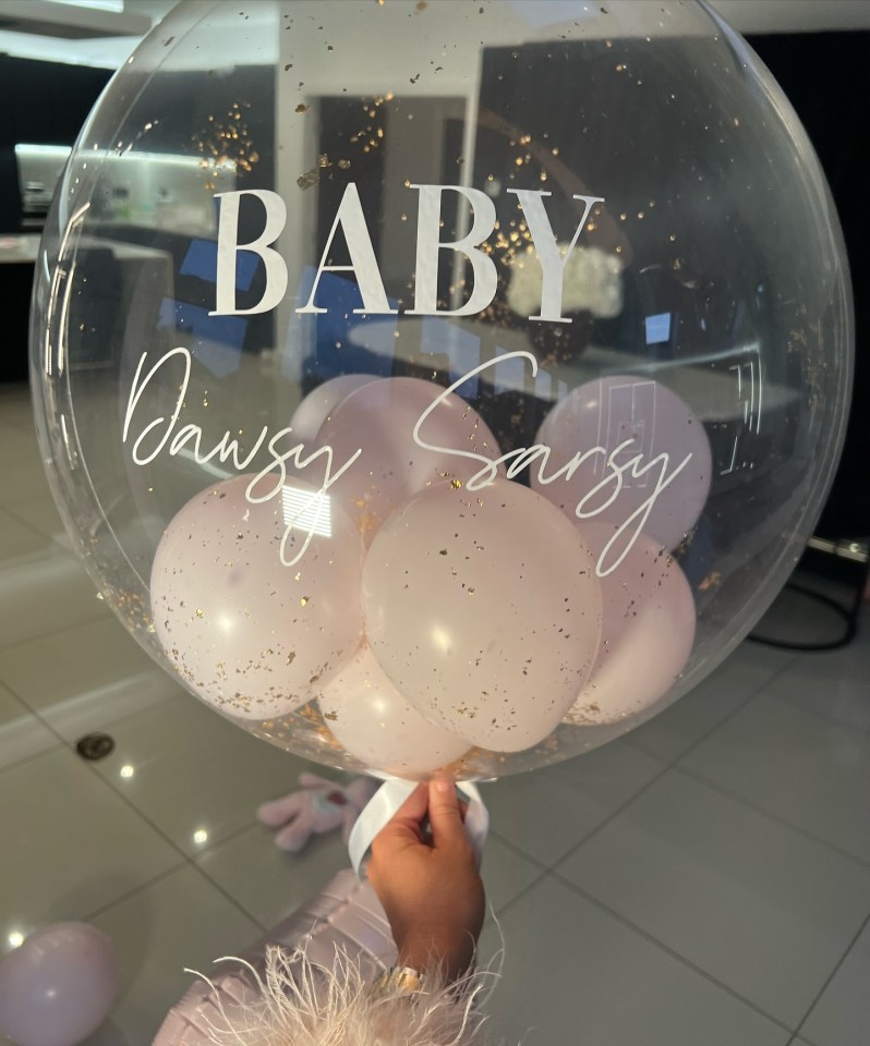 a clear balloon with the word baby written on it