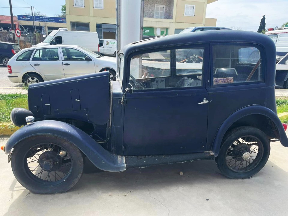 an old car is parked in front of a building that says fresh