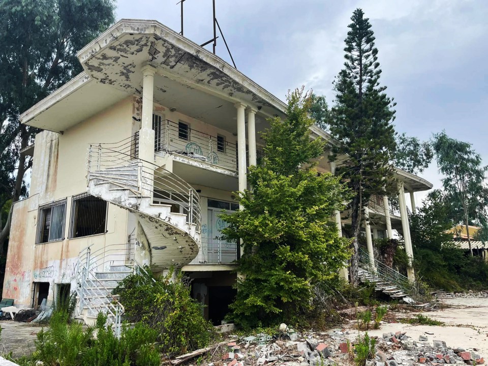 an abandoned house with a spiral staircase leading up to the second floor