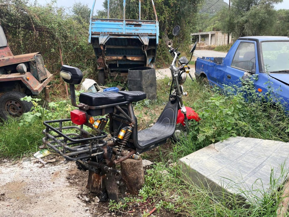 a motorcycle is parked next to a blue truck