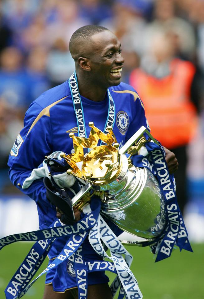 a man holding a trophy that says barclays on it