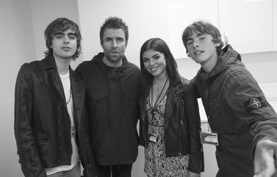 a group of people posing for a photo with one wearing a stone island jacket