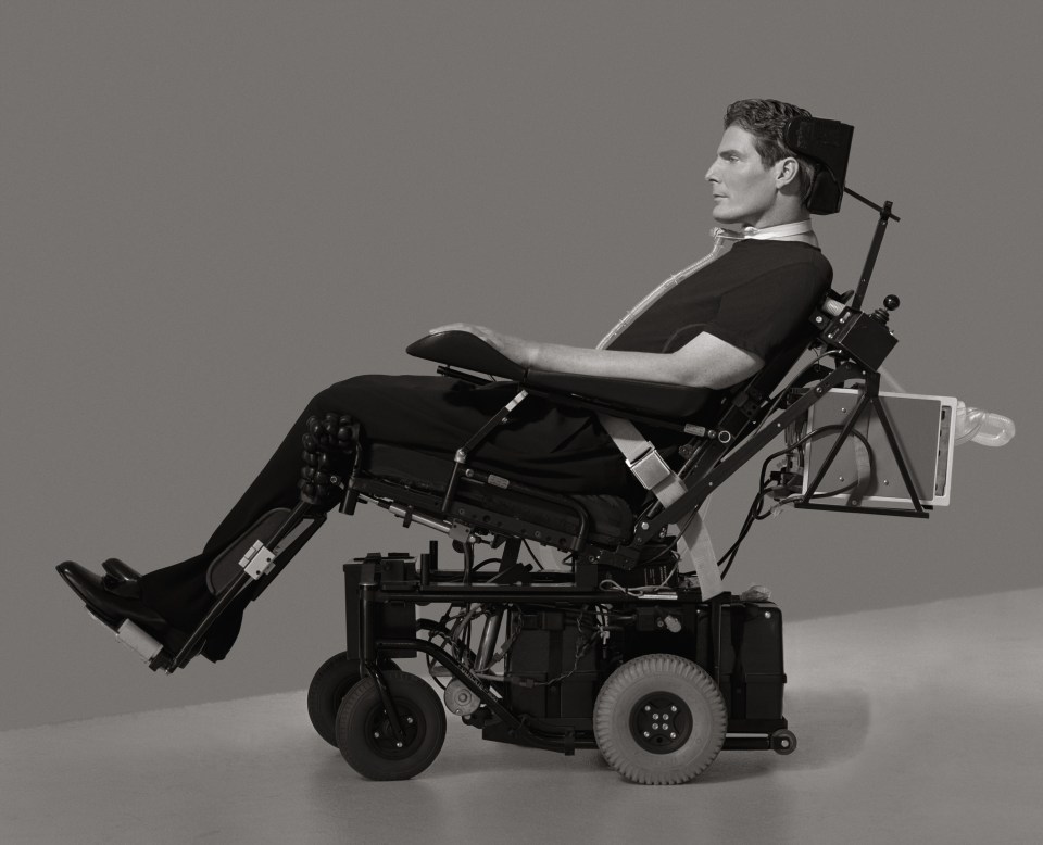 a man in a black shirt is sitting in a wheelchair
