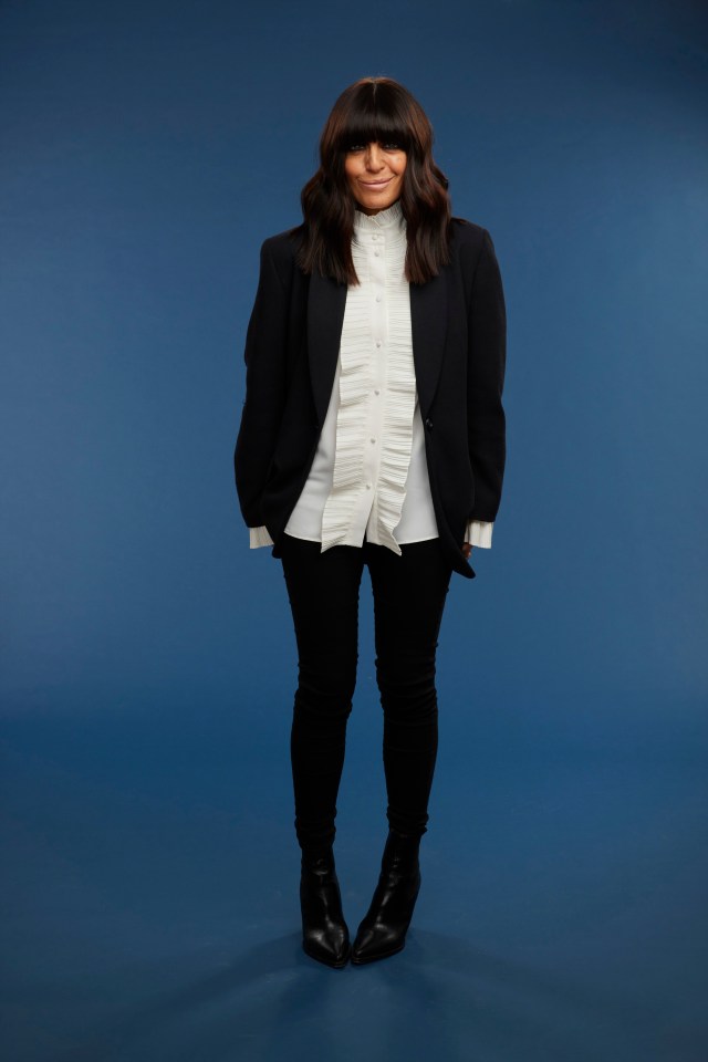 a woman wearing a black jacket and a white shirt