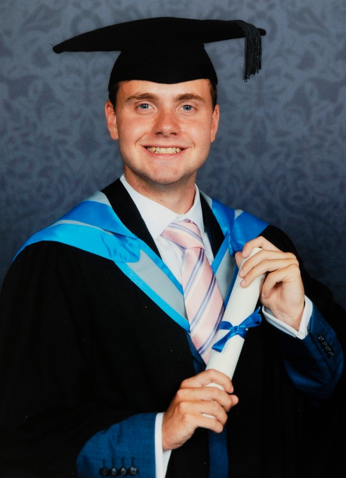 a man in a graduation cap and gown holds a diploma