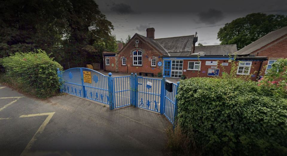 a school with a blue fence and a sign that says no parking