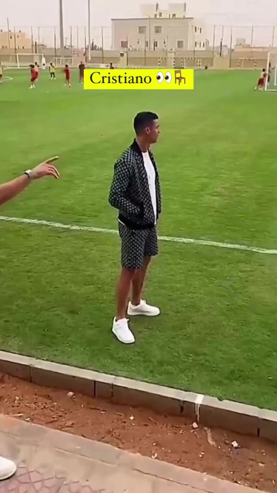 cristiano ronaldo is standing on a soccer field