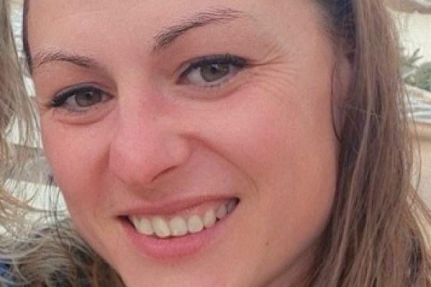 a woman wearing sunglasses smiles for the camera