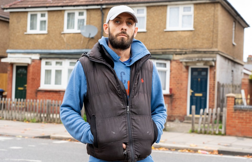 a man wearing a vest with the letter g on it