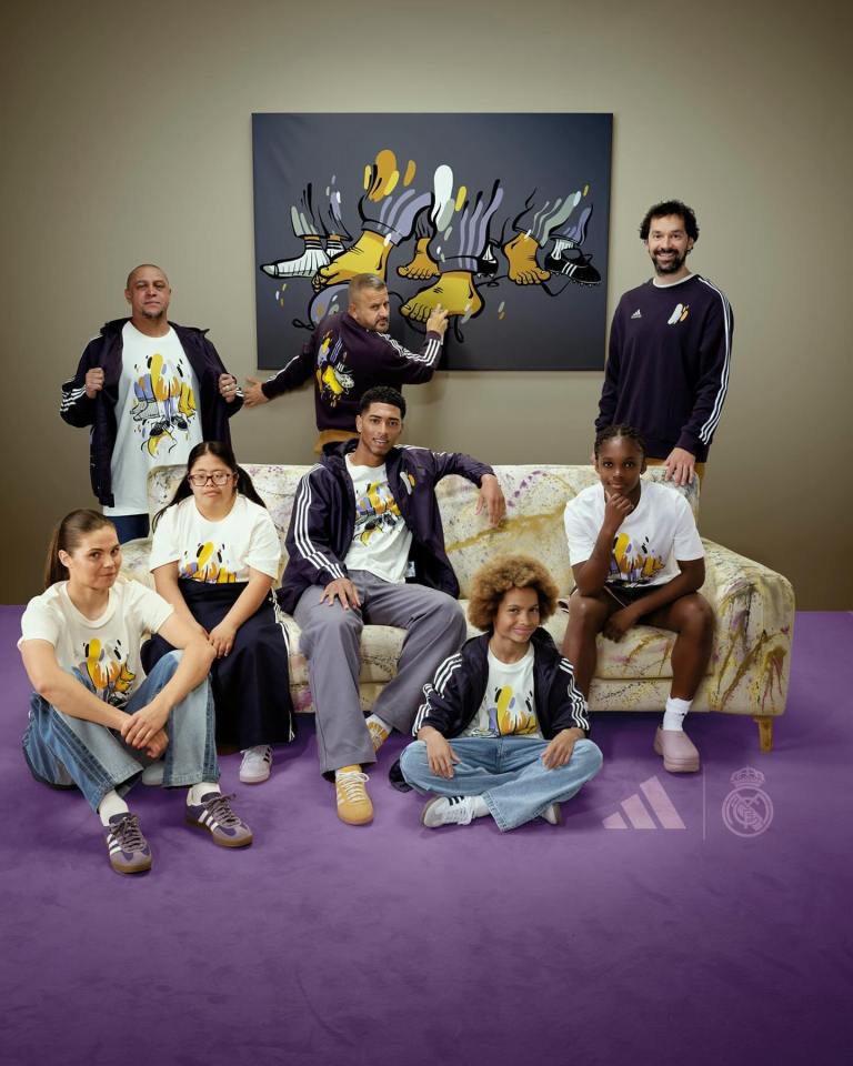 a group of people sitting on a couch wearing adidas shirts