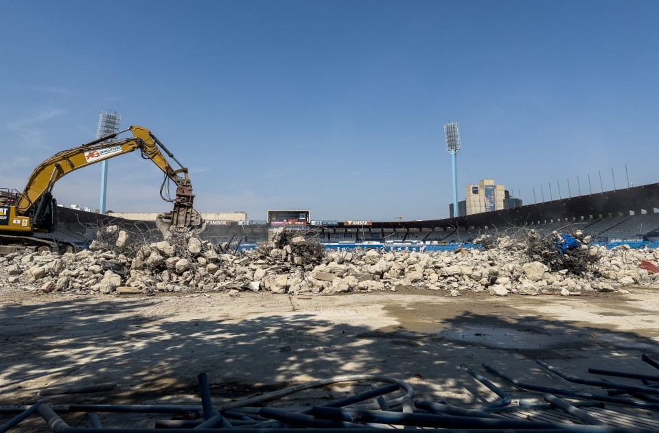 a construction site with a cat excavator in the foreground