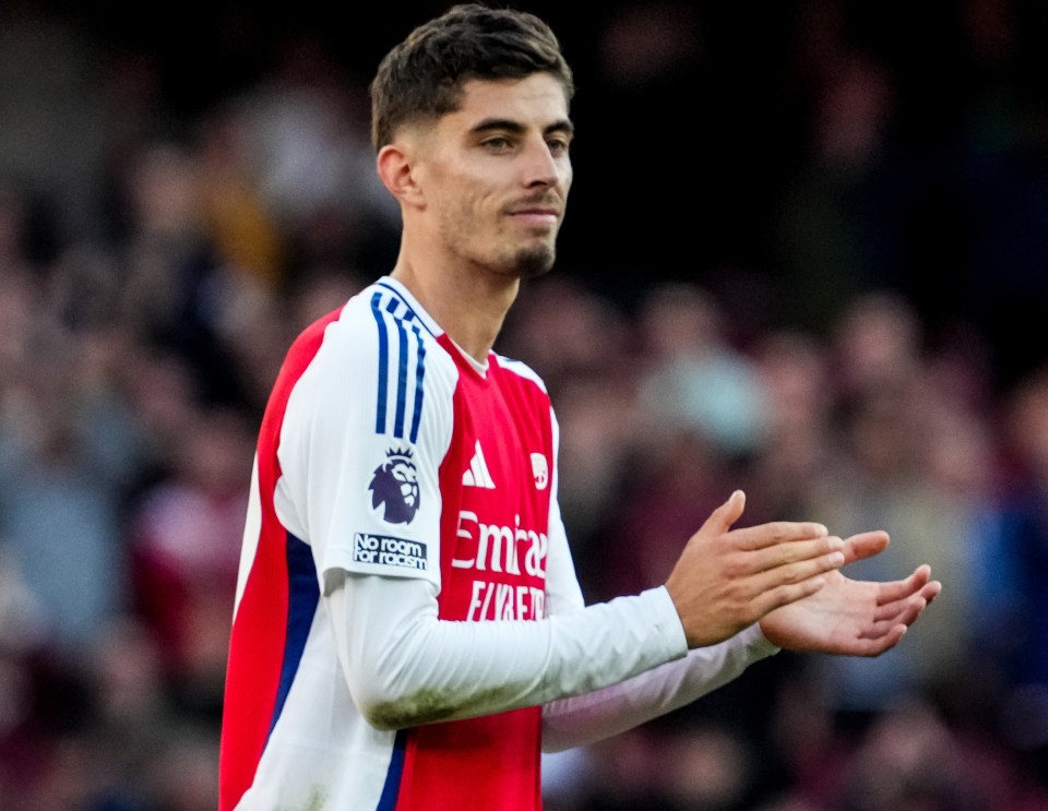 a soccer player wearing a jersey that says emirates on it