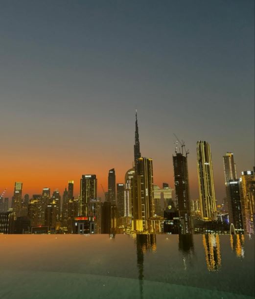 a view of the city skyline from an infinity pool