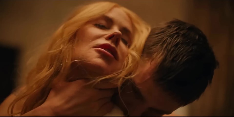 a man is kissing a woman 's neck in a dark room