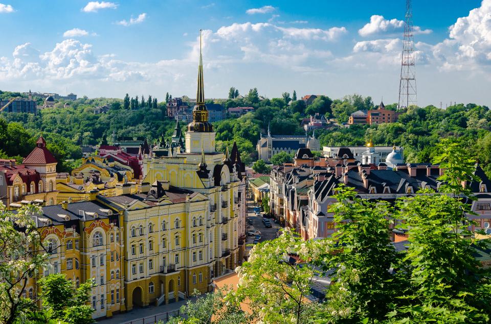 an aerial view of a city with a yellow building in the middle