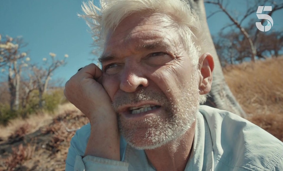 a close up of a man 's face with the number 5 behind him