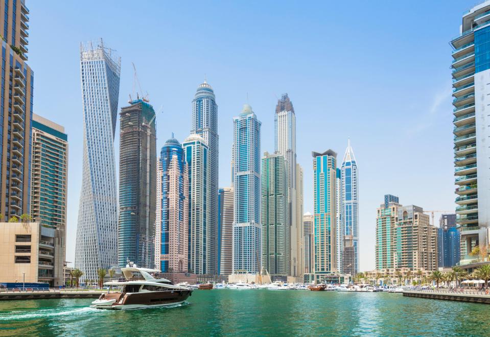 a boat is in the water in front of a city skyline