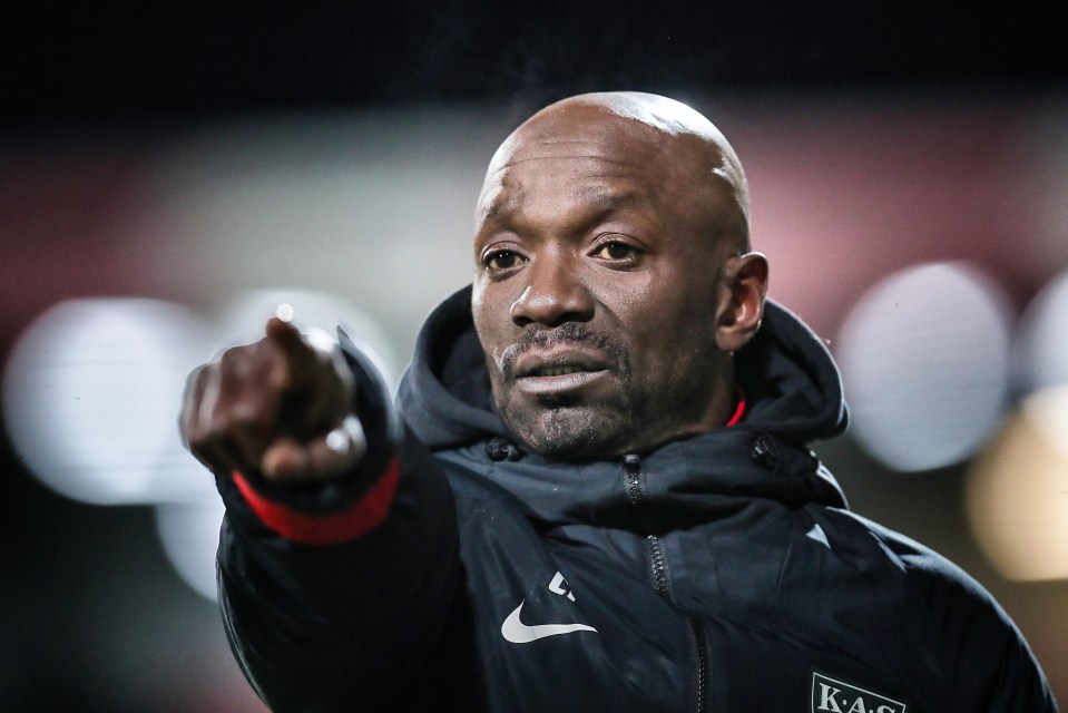 a man wearing a black jacket with the word kas on it
