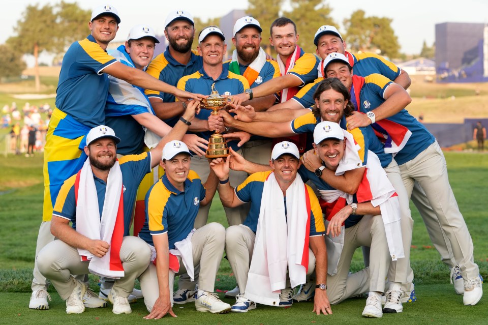 a group of men holding a trophy with the letter r on their hats