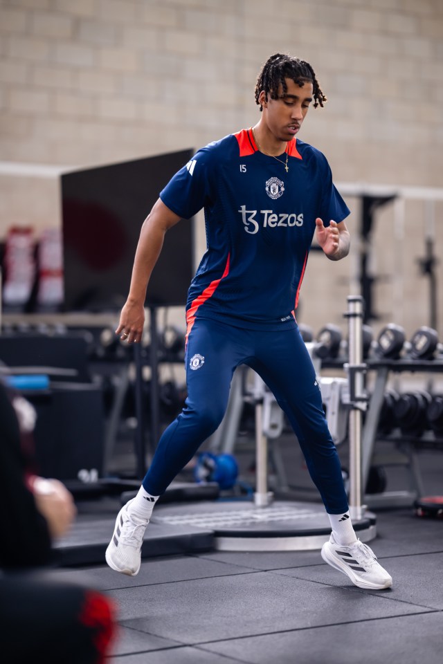 a man wearing a shirt that says tezos on it