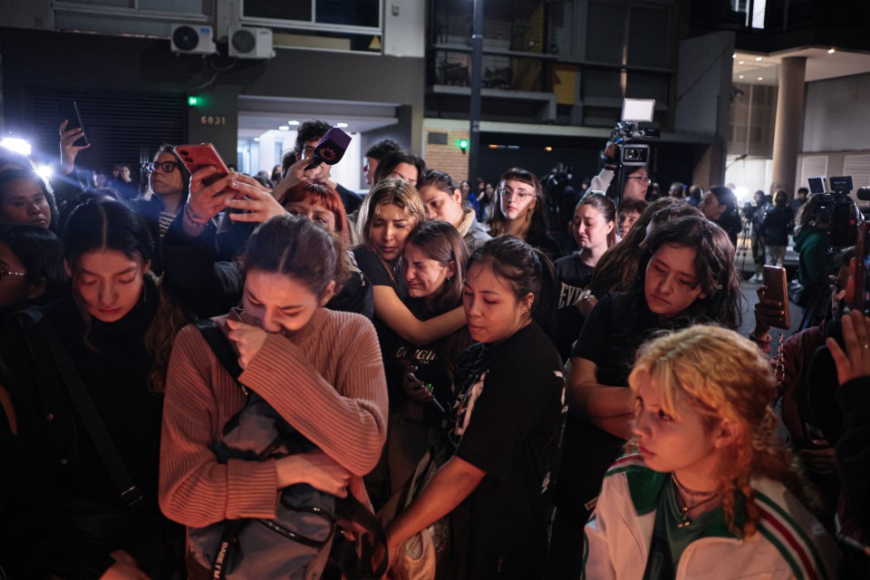 a group of people are gathered in front of a building with the number 6031 on it