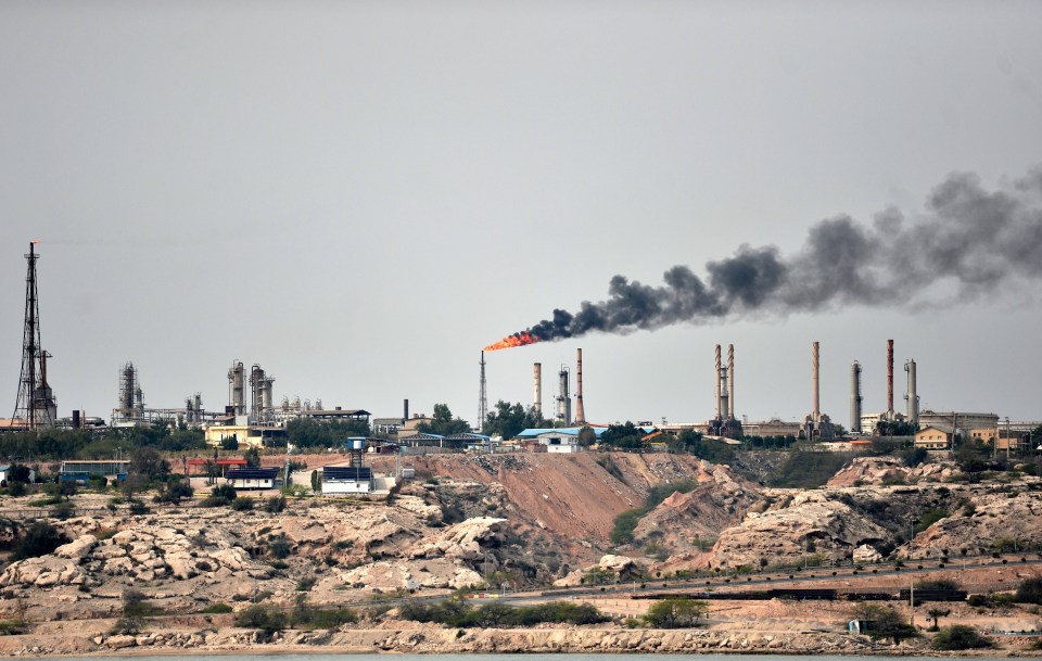 a factory with smoke coming out of the chimneys