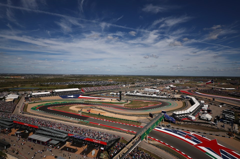 an aerial view of a race track with a large crowd watching