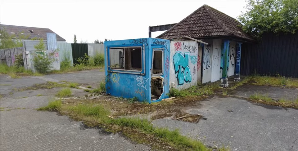 a blue building with graffiti on it including the letter l