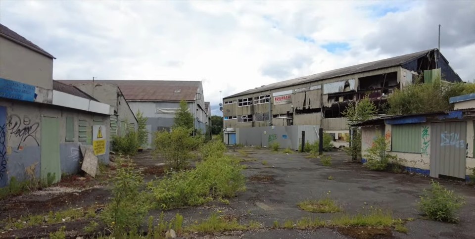 a building with a sign on it that says ' for sale '