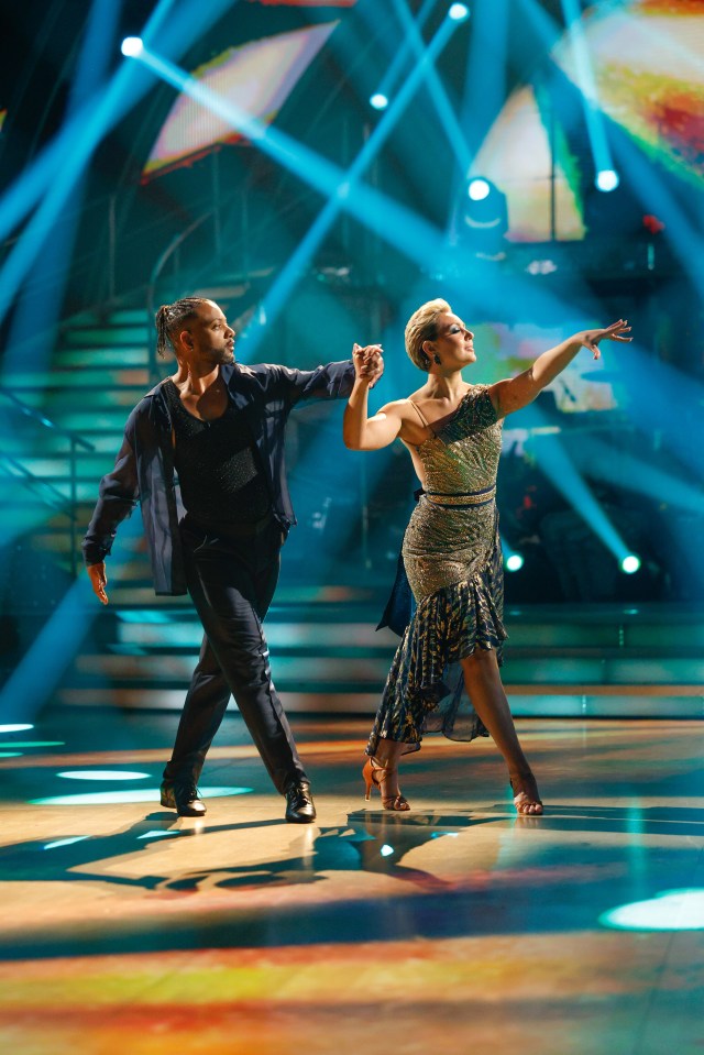 a man and a woman are dancing on a stage